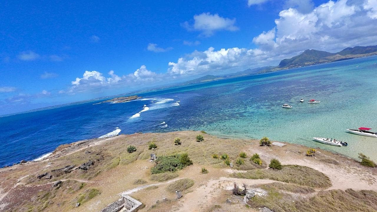 Aerial view of island with speedboats anchored in Mauritius