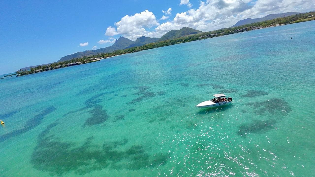 Aerial view of speedboat in crystal clear waters of Mauritius