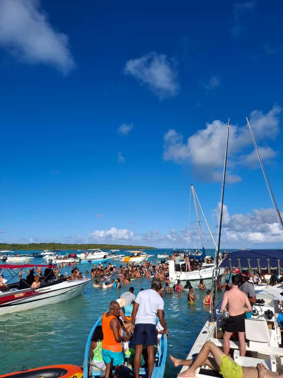 Boat party with people swimming in crystal clear Mauritius lagoon