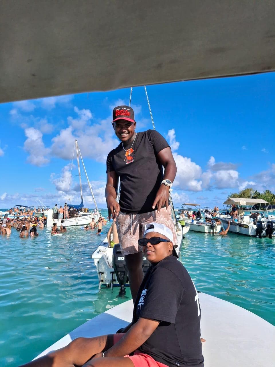 Messiah Excursion crew on speedboat with happy tourists in Mauritius lagoon
